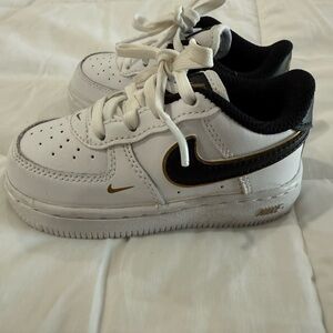 Nike Kids White Sneakers with Black and Gold Accents